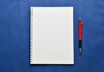 Top view, empty notebook on a blue background