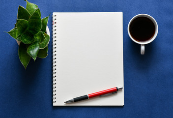 Top view, empty notebook on a blue background