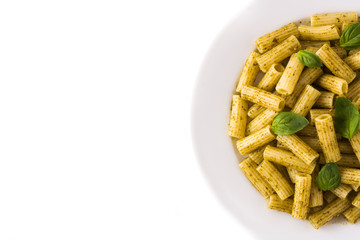 Penne pasta with pesto sauce and basil on a plate isolated on white background. Top view. Copyspace