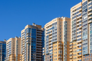 Fototapeta na wymiar Urban houses against the blue sky.