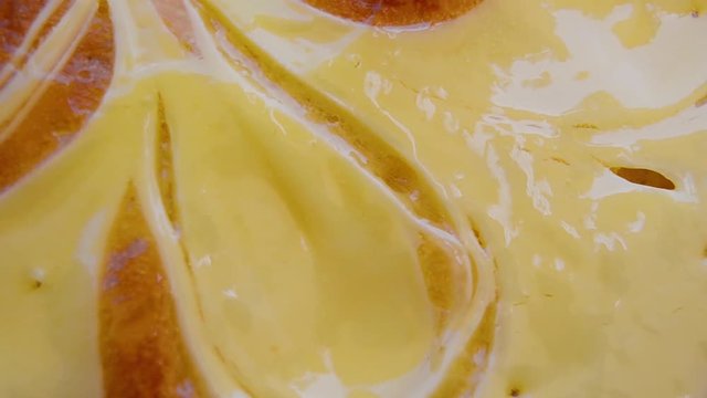 extreme close up top view of rotating vanila cake