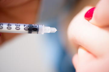 Diabetes patient insulin shot by syringe with dose of lantus, su