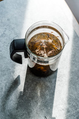 Green Tea with French Press in Daylight