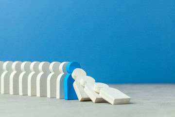 Domino effect in business. One businessman falls and brings down other figures of employees....