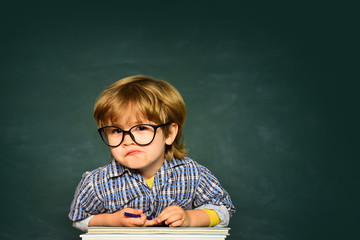 Boy from elementary school at the school yard. Cute little preschool kid boy in a classroom.