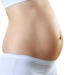 Pregnant woman with belly in the early stages of pregnancy.