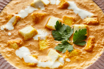 Close up texture of Shahi paneer north Indian vegetarian gravy meal with vegetables and white sauce and butter paneer cottage cheese spicy food served with parsley