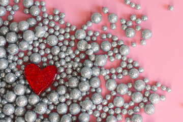 Balls shiny wall background texture, brooch heart. Pink backgrownd