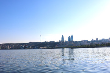 Naklejka premium View from The Caspian Sea to Flame Towers. Baku Flame Towers is the tallest skyscraper in Baku, Azerbaijan