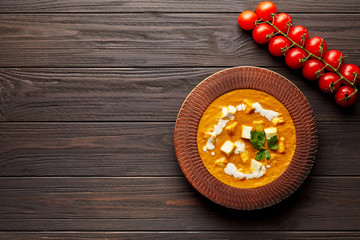 Shahi paneer Indian vegetarian masala gravy Pakistani meal with vegetables and butter paneer cottage cheese spicy food restaurant style north India dish with cherry tomatoes on dark wooden background