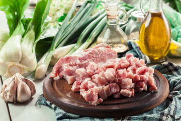 Raw pork belly pieces on a cutting board