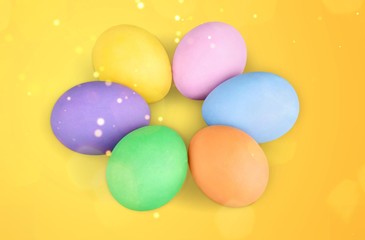 Colorful Easter eggs close up on yellow background