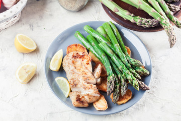 Fried cod fillet with green asparagus