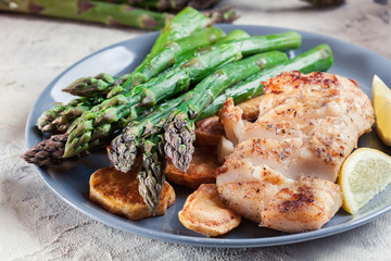 Fried cod fillet with green asparagus