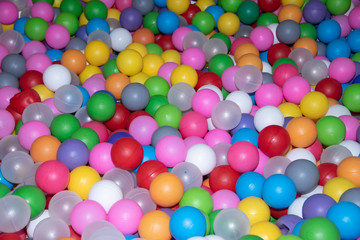 Fototapeta na wymiar Background colored balls for a dry pool. Bright colors of balls. Plastic balls a lot