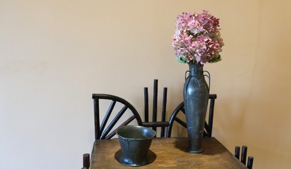 bowl and a vase of flowers on the table