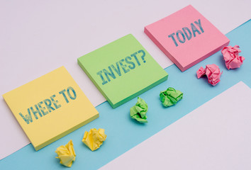 Word writing text Where To Invest question. Business photo showcasing asking about actions or process of making more money Note papers and stationary placed sideways on top of softhued backdrop