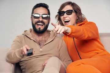 Family watching 3D film on TV