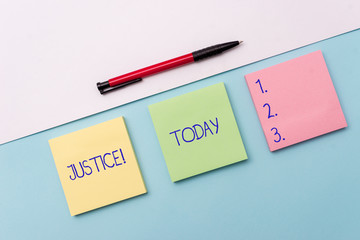 Conceptual hand writing showing Justice. Concept meaning impartial adjustment of conflicting claims or assignments Stationary placed sideways on top of the softhued backdrop