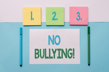 Text sign showing No Bullying. Business photo text stop aggressive behavior among children power imbalance Note papers and stationary placed sideways on top of softhued backdrop