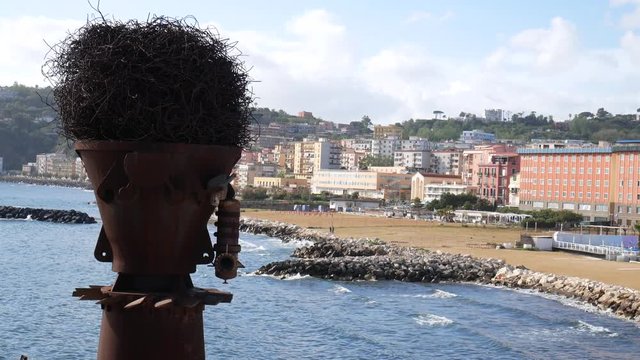 Naples, Campania, Italy - april 24 2019: panorama of the beach of Bagnoli with an artistic steel installation, reclaimed area from the remains of former Italsider steelwork