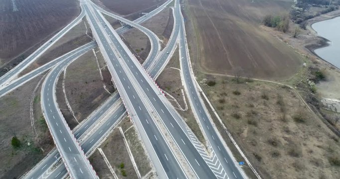 Aerial high drone flight over Highway and overpass. Road junction. Transportation and infrastructure development