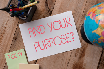 Writing note showing Find Your Purpose question. Business concept for reason for something is done or for which exists Writing equipments and sheets with artificial globe on the wooden desk