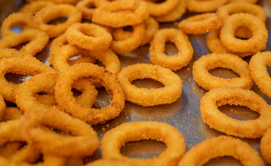 Many crunchy fried onion rings are ready to service in a hotel restaurant