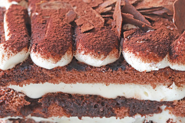 Chocolate pastry with whipped cream on white background