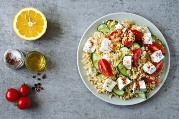 Salad with bulgur, vegetables and feta cheese. Healthy food. Middle Eastern style.