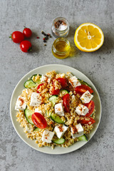 Salad with bulgur, vegetables and feta cheese. Healthy food. Middle Eastern style.