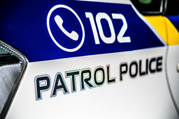 The inscription on the patrol police of Ukraine and the emergency phone number of the police call.