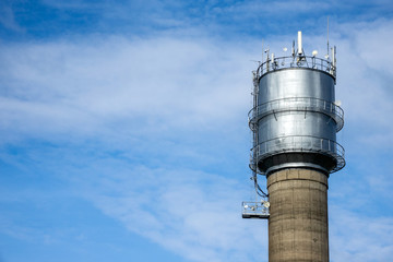 Water tower on sky background