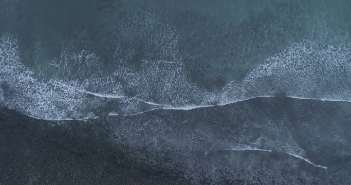 Top down aerial shot of waves breaking on Talisker bay, Isle of Skye.