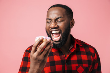 Portrait of a happy excited african man standing isolated