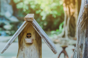 Hand made wooden bird house nest  in public Park , hand wood shelter for birds .