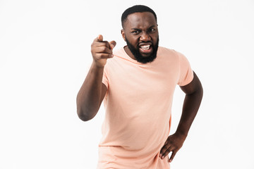 Portrait of an angry african man wearing t-shirt standing