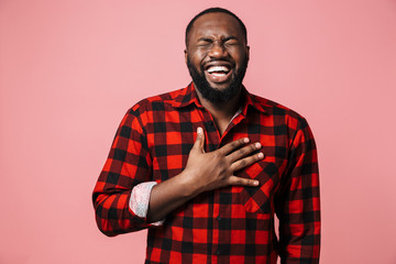 Obraz premium Portrait of a happy african man wearing plaid shirt