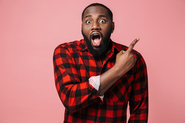 Portrait of a shocked african man wearing plaid shirt