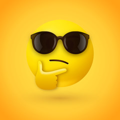Thinking face emoji with sunglasses - emoticon face shown with a single finger and thumb resting on the chin wearing hipster sunglasses on yellow background - 269015771