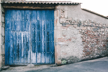 Blue wooden old door on a stone wall