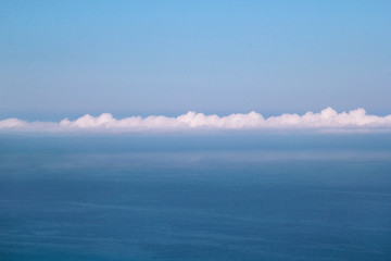 Fototapeta premium Sea, sky, beautiful structure of clouds, majestic landscape with seascape at calm blue water on horizon of mediterranean coast. Beautiful view, natural environment. Summer season, travel and holiday.
