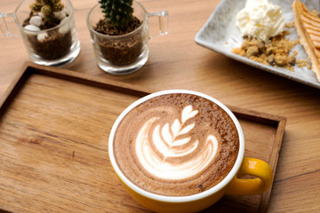Hot latte and apple tart on a wooden table