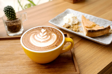 Hot latte and apple tart on a wooden table