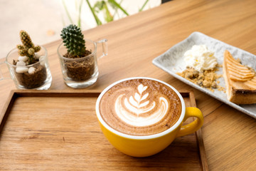 Hot latte and apple tart on a wooden table