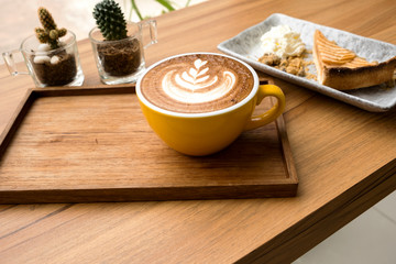 Hot latte and apple tart on a wooden table
