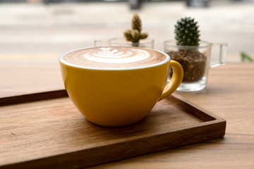 Hot latte on a wooden table