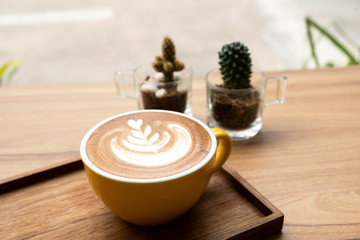 Hot latte on a wooden table