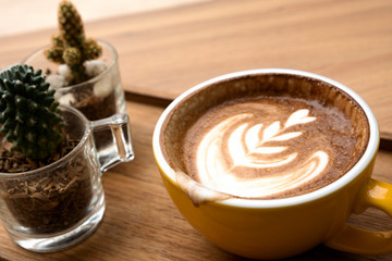 Hot latte on a wooden table