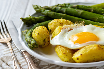 Grilled asparagus with fried egg and roasted potatoes.